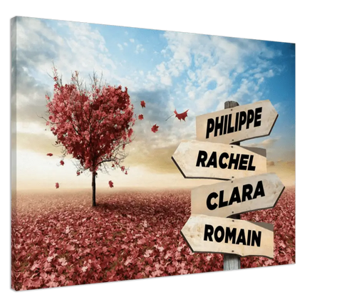 tableau personnalisé prénoms cœur rouge avec impression sur toile d’un arbre aux feuilles rouges en forme de cœur entouré de pétales tombés sous un ciel bleu.