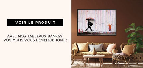 un tableau encadré de style banksy représentant une silhouette noire tenant un parapluie et marchant devant une petite figure orange accroché à un mur marron dans un article intitulé banksy dismaland